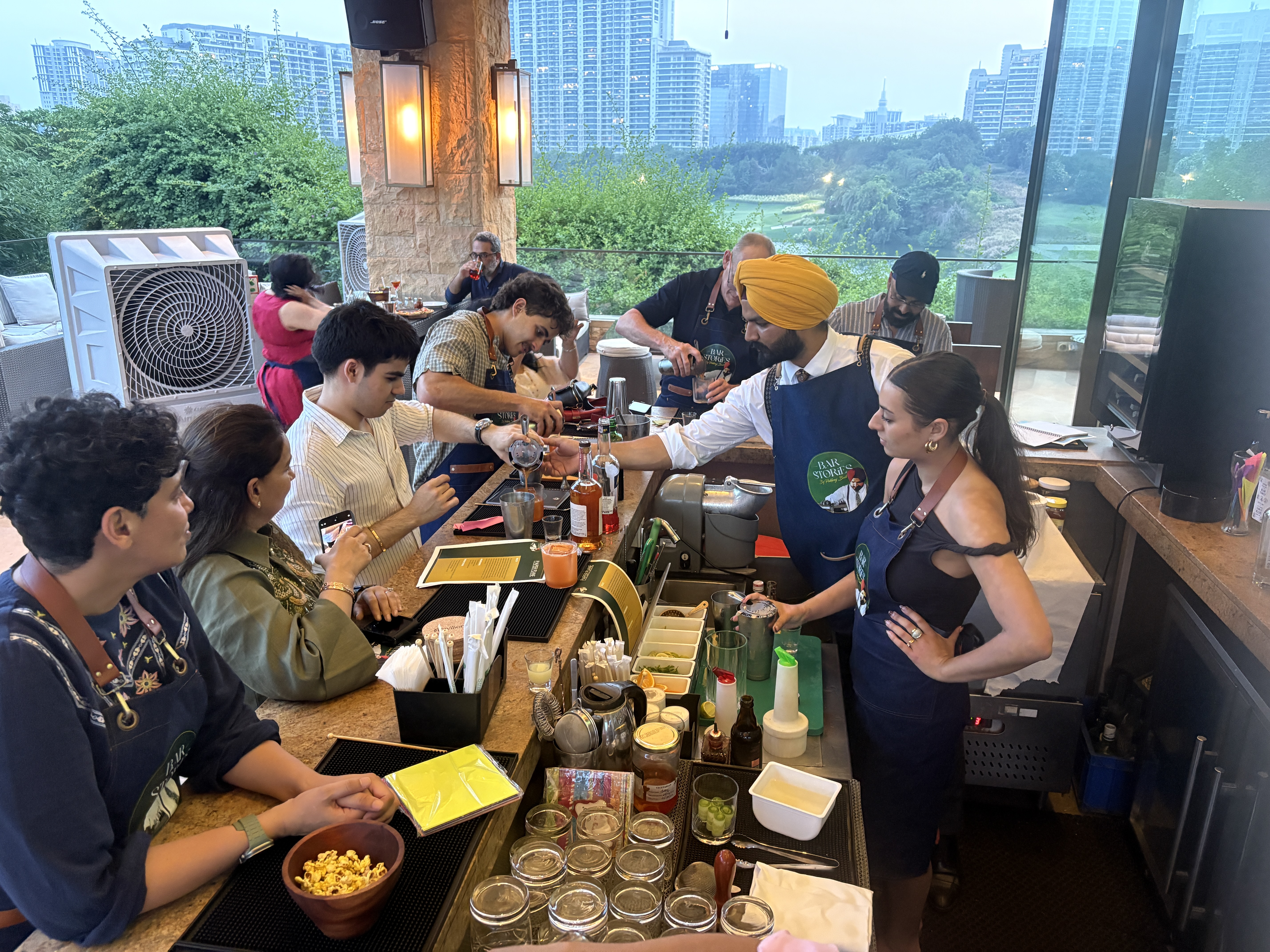 Pukhraj Bedi working behind a live bar with guests